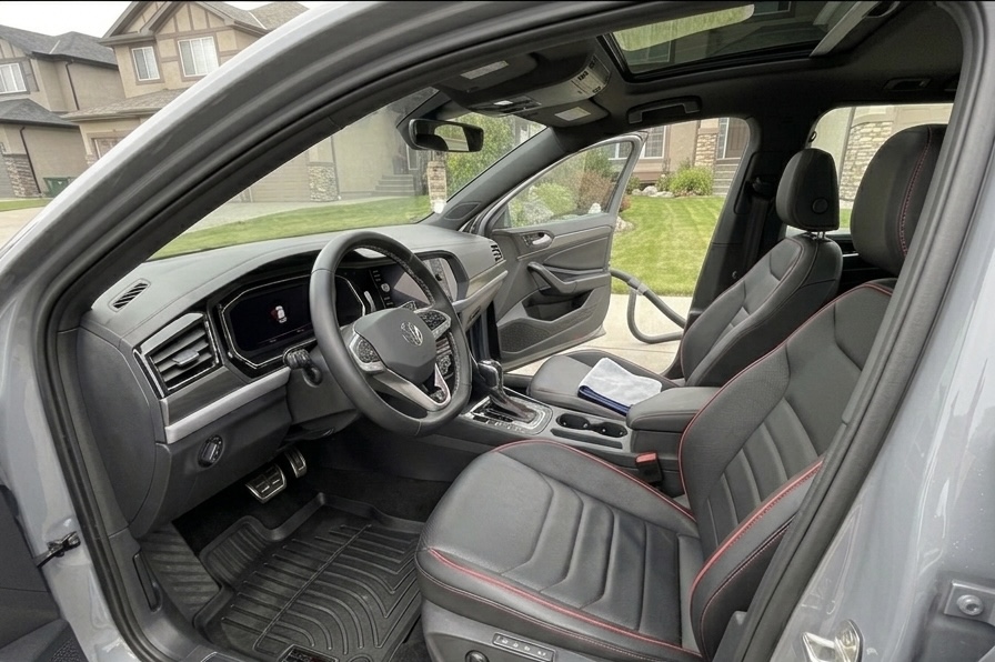 Detailed Volkswagen interior with black and red stitched seats
